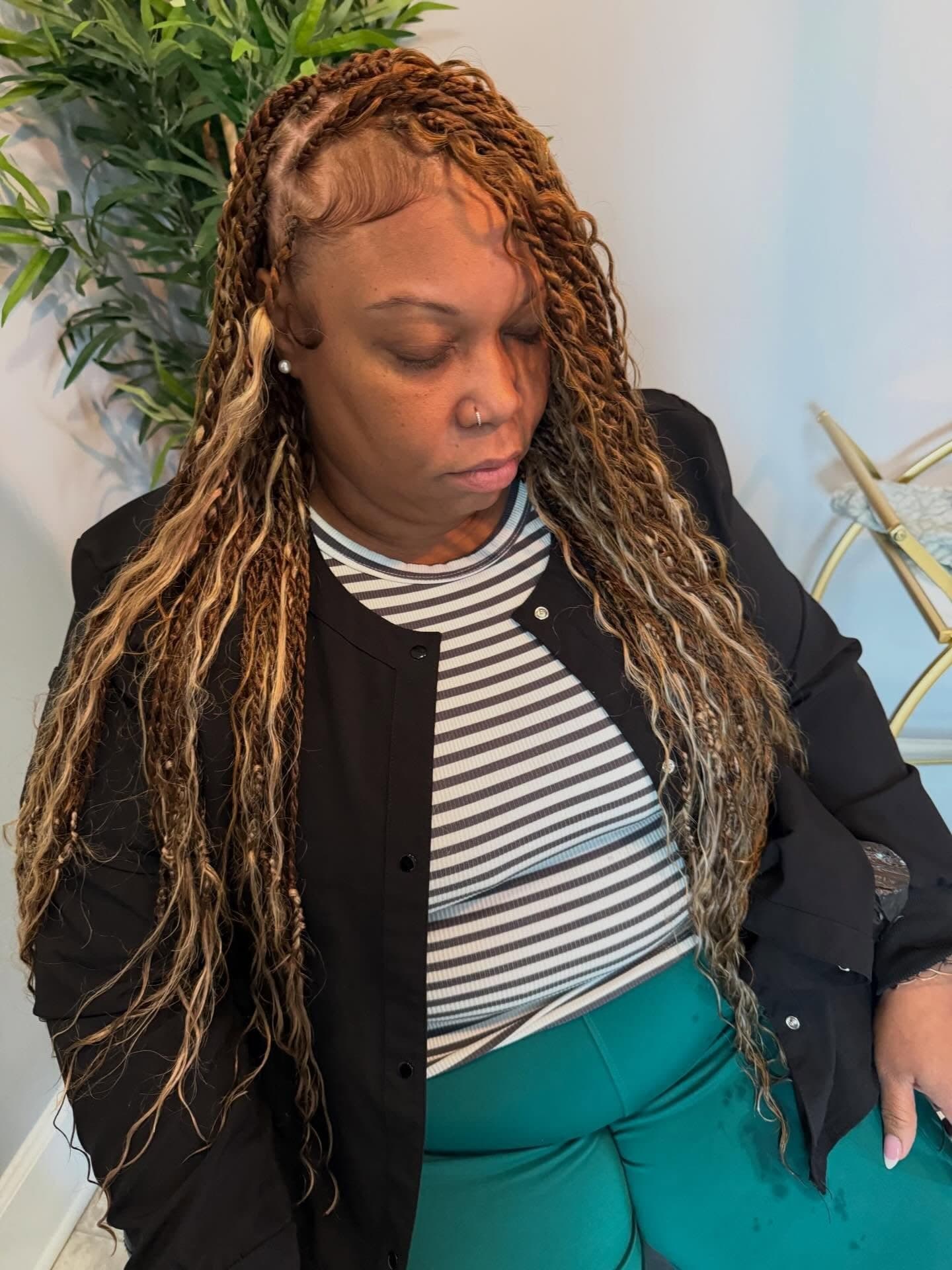 Honey-blonde boho locs falling well past the shoulder, textured and softly curled at the ends