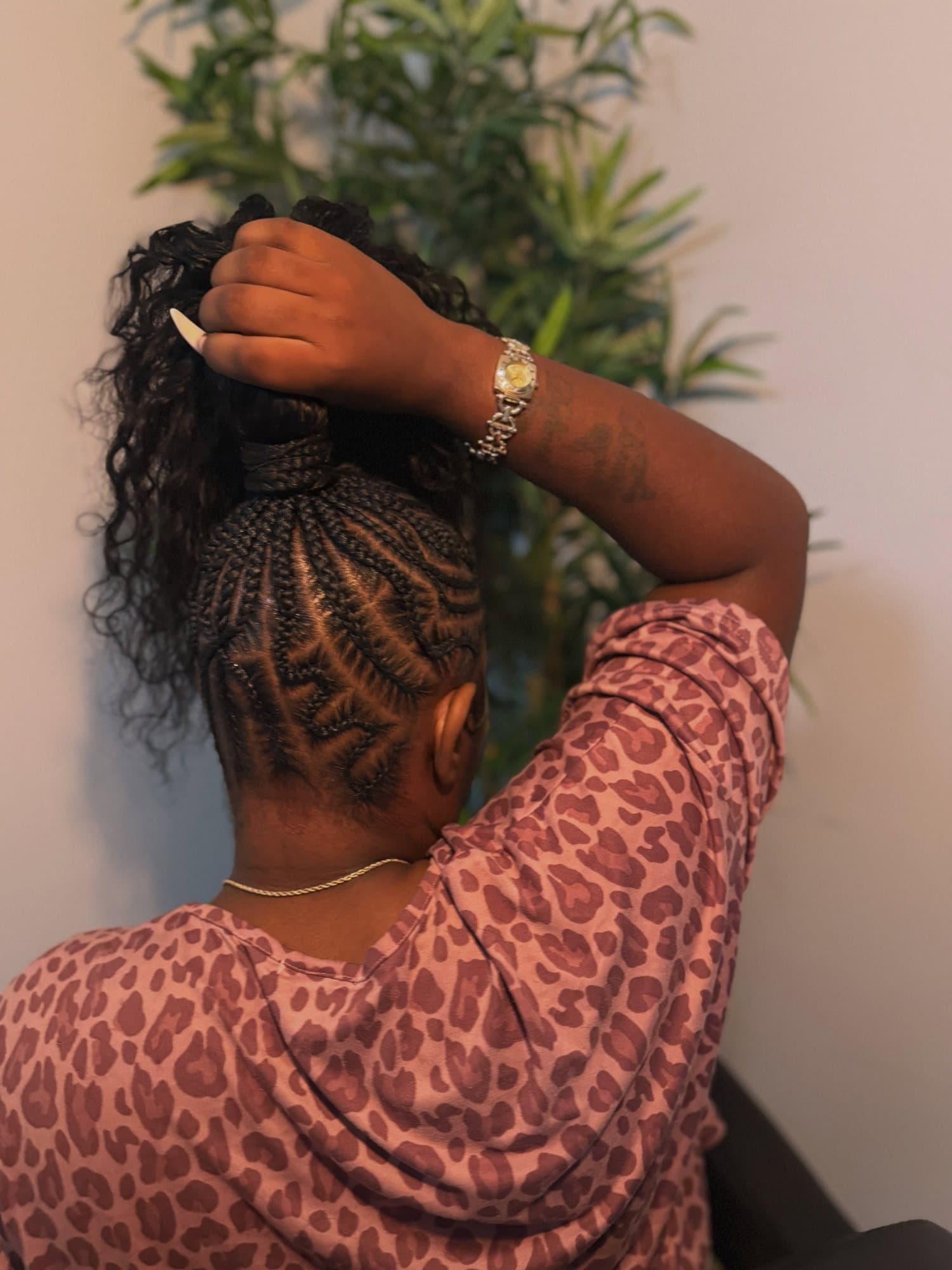 Close detail of banded stitch braids running in straight lanes from the hairline back to the crown